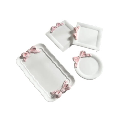 white ceramic dishes with pink bows