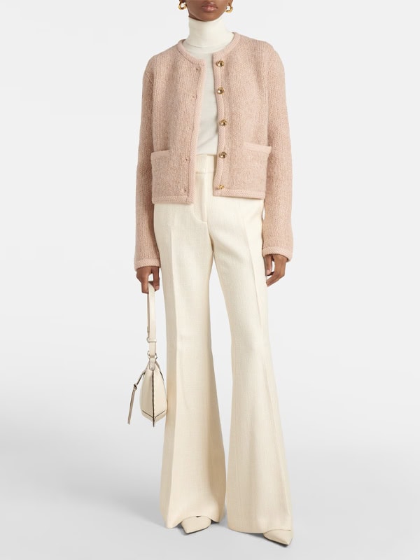 pink fuzzy sweater with cream flare trousers