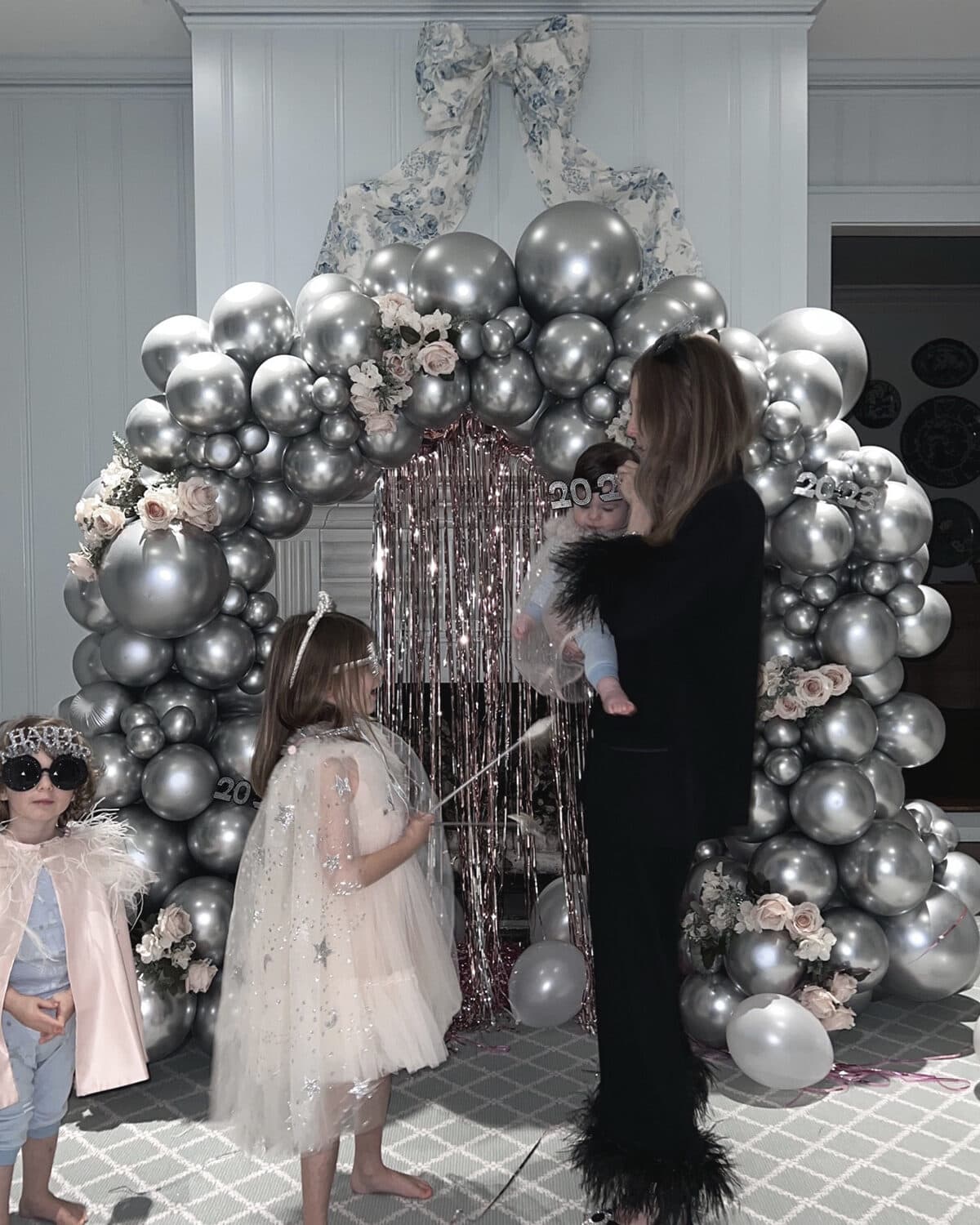 At home new Years Eve Ideas with kids and silver balloon arch