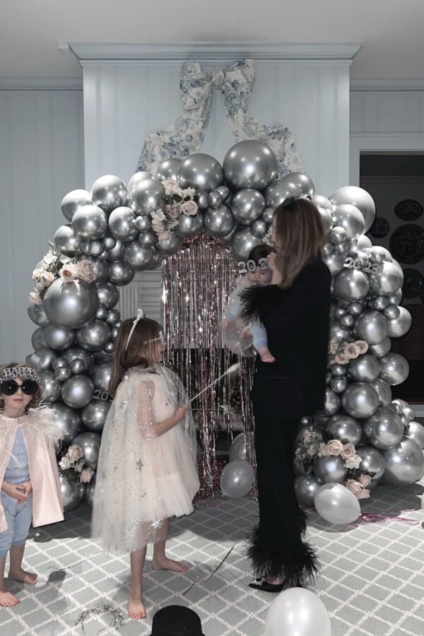 At home new Years Eve Ideas with kids and silver balloon arch