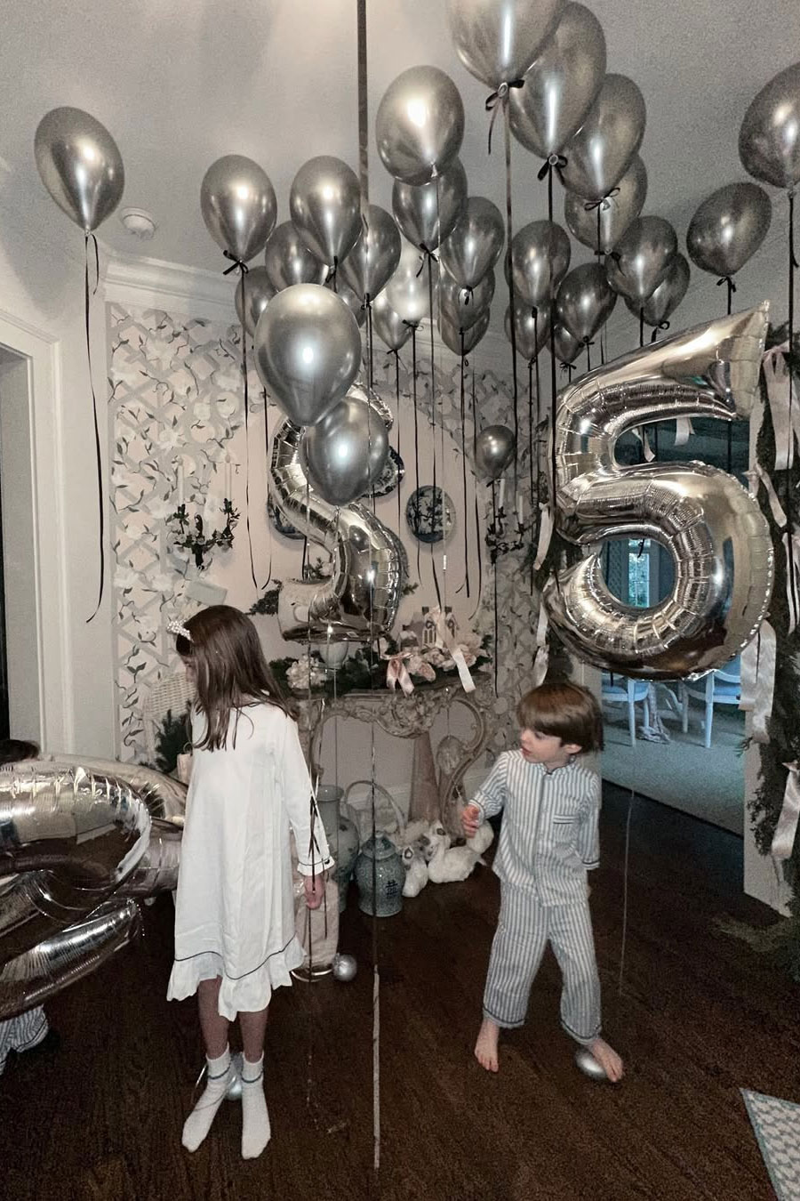 family new years eve at home with silver balloons