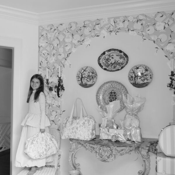 black & white photo of elle in front of floral wall