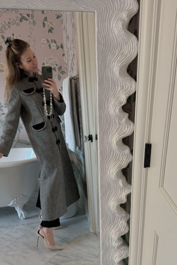 Emily wearing long peacoat and bow tie heels