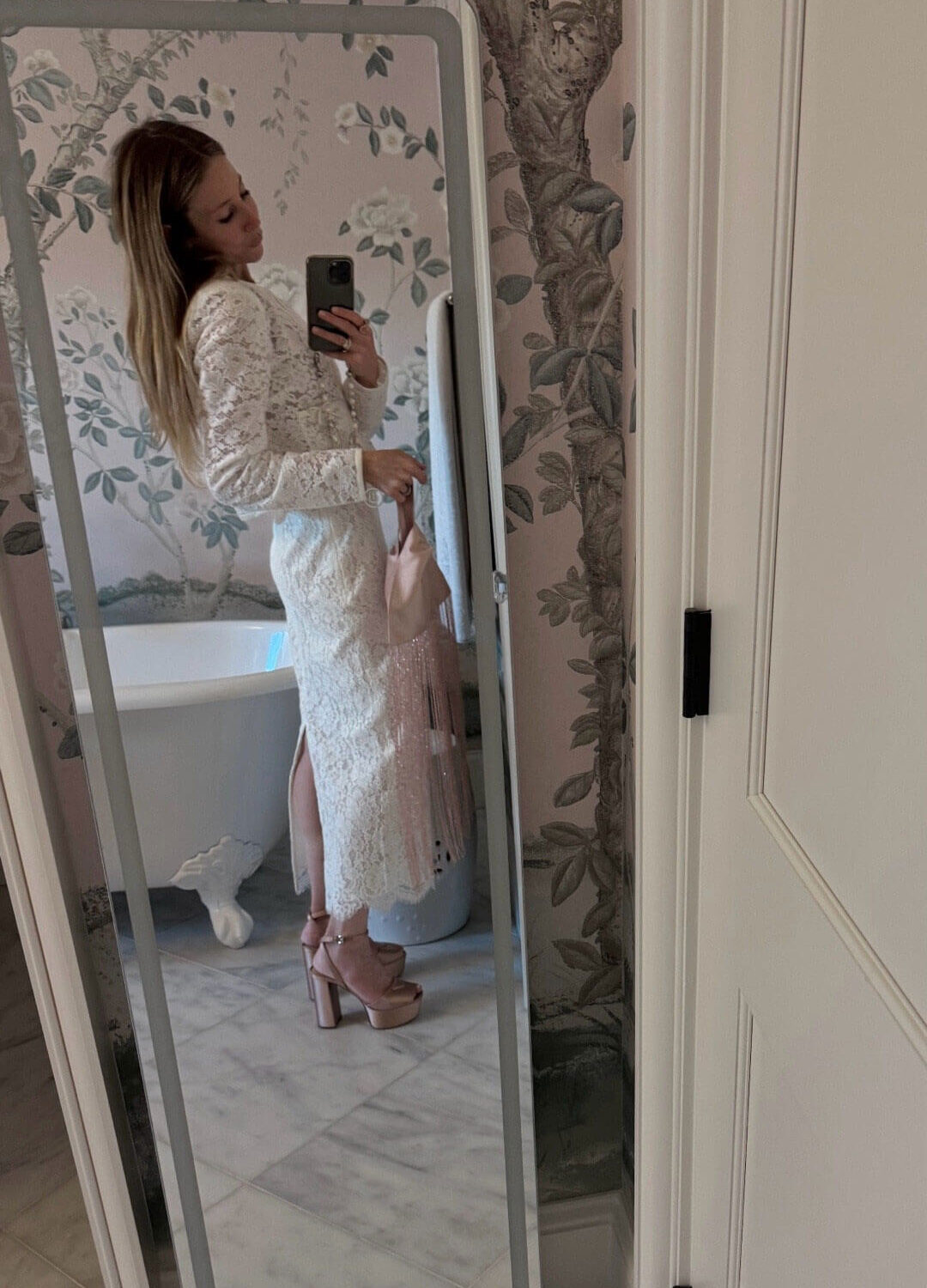 Emily wearing white lace loveshackfancy skirt and jacket set