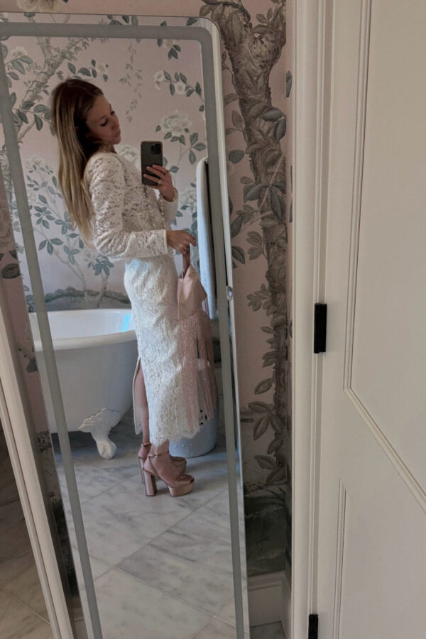 Emily wearing white lace loveshackfancy skirt and jacket set