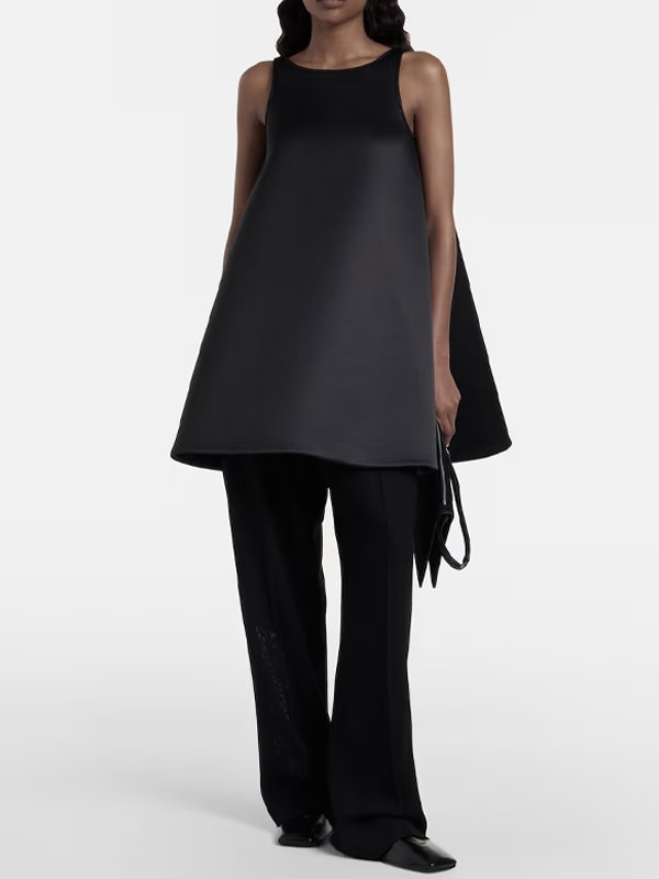 woman wearing satin a-line top and black pants