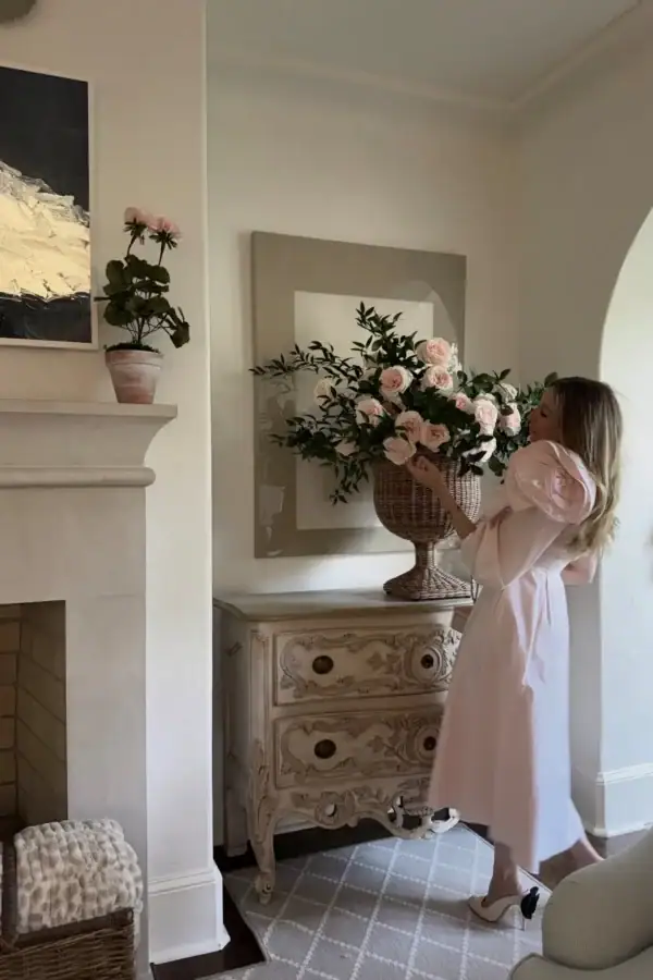 Pretty in pink! Emily Hertz in pink dress with garden roses in livingroom