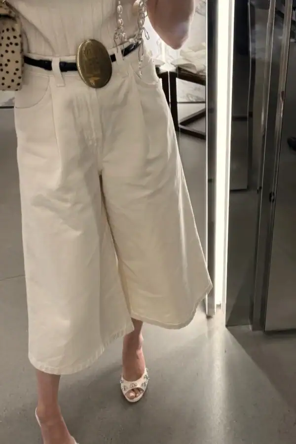 Emily wearing white Gaucho pants and Celine belt