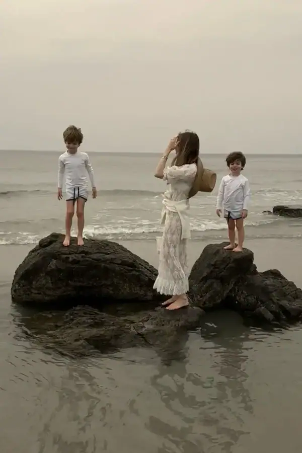 Emily wearing Doen at the beach with kids