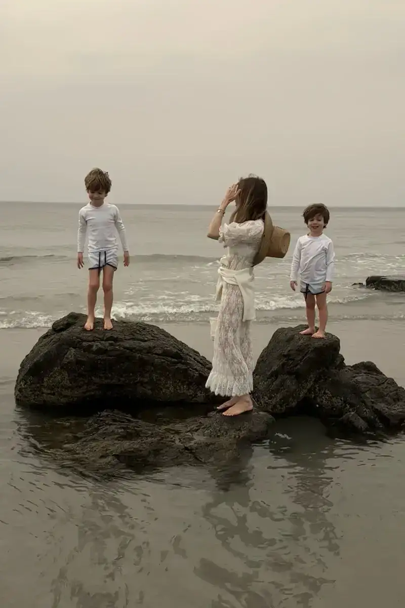 Emily wearing Doen at the beach with kids