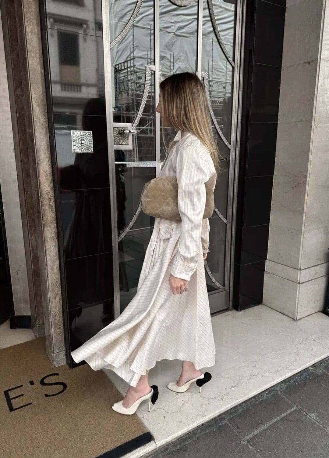 Emily wearing a striped dress for London trip