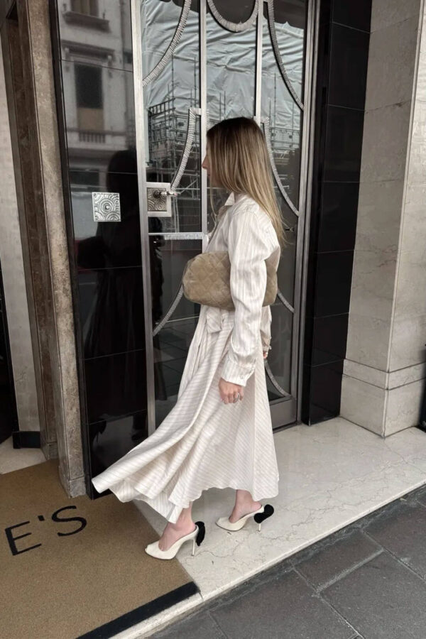 Emily wearing a striped dress for London trip