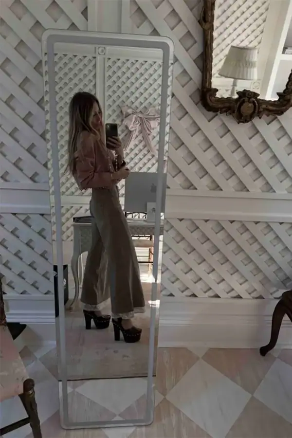 Emily wearing Chloe Meret clogs with Chloe crop top and lace jeans