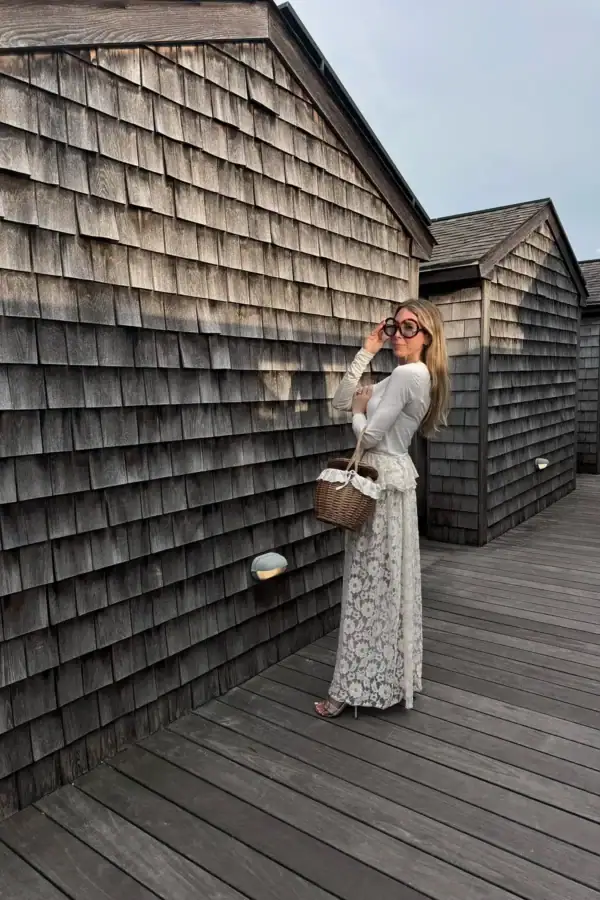 Emily wearing long lace skirt, white long sleeve top, Celine sunglasses and basket bag