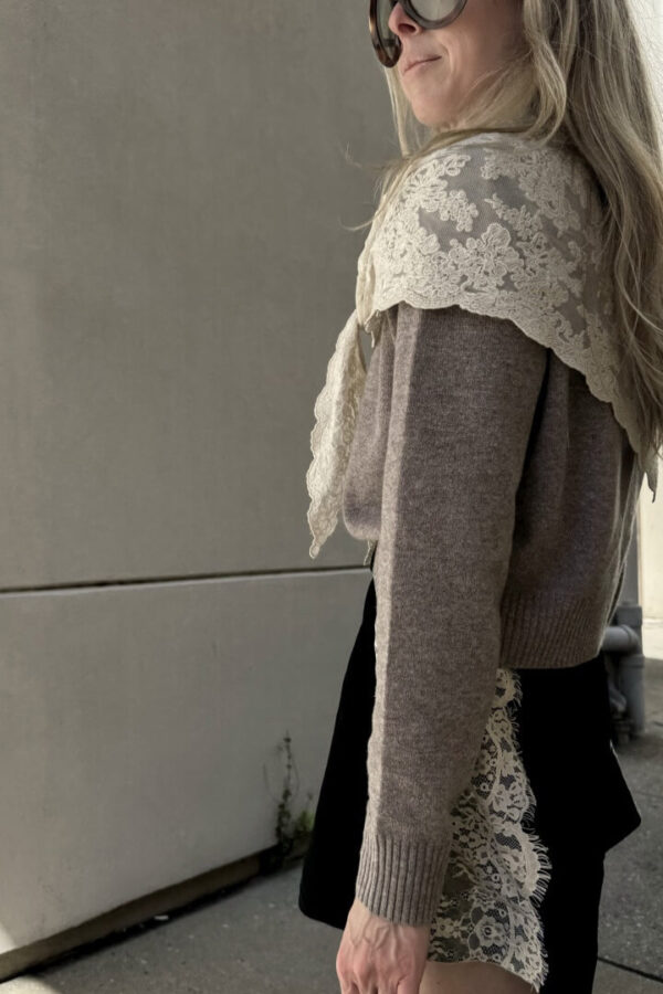 Emily wearing Sea Kirra lace cardigan with cape scarf